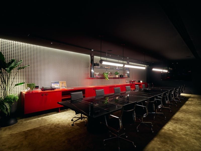 Novotel St Kilda. The meeting room, with a long table and red joinery.