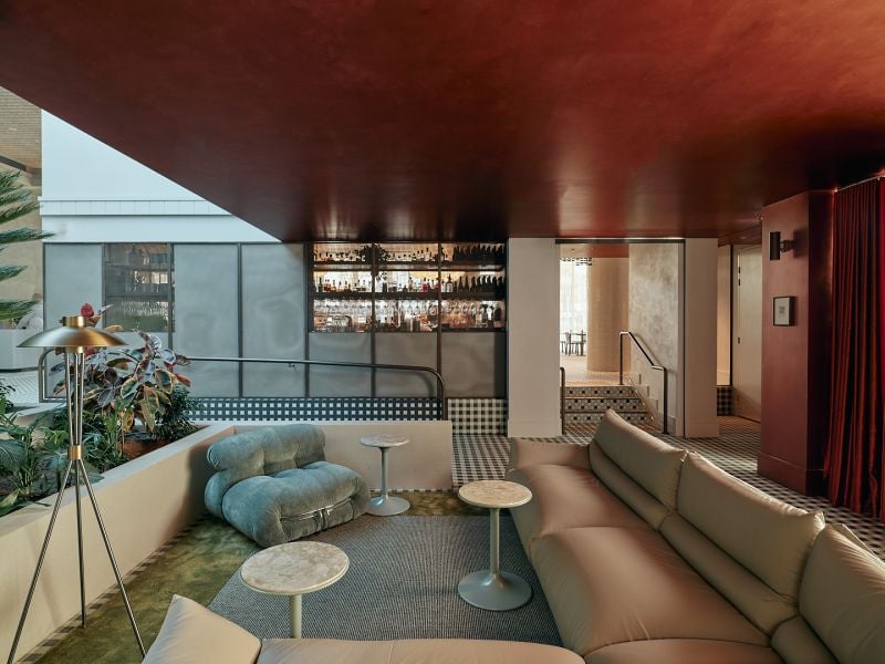 Novotel St Kilda. The sunken lounge beside the atrium, with the bar behind it.